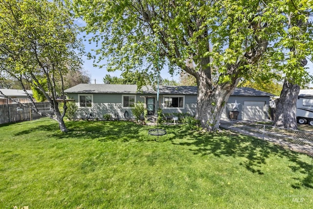 ranch-style house with a front lawn, fence, and driveway