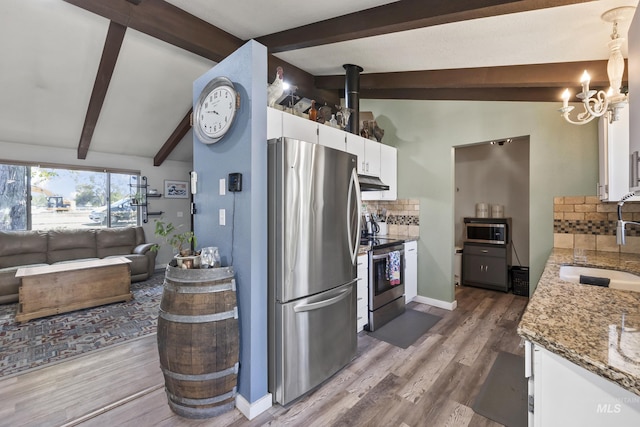 kitchen featuring a sink, white cabinets, stainless steel appliances, and tasteful backsplash