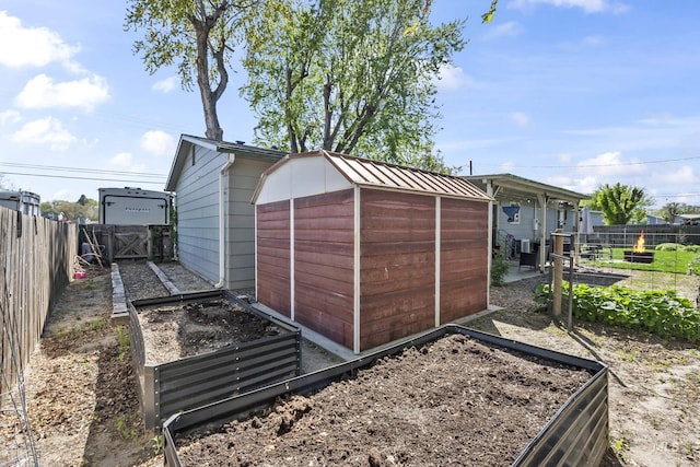 view of shed with a garden, a fenced backyard, and central AC unit