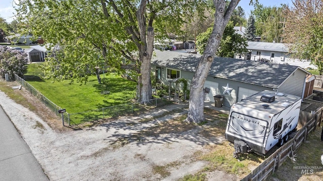 view of front of home featuring roof with shingles and fence