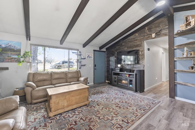 living room featuring beamed ceiling, wood finished floors, high vaulted ceiling, and a fireplace