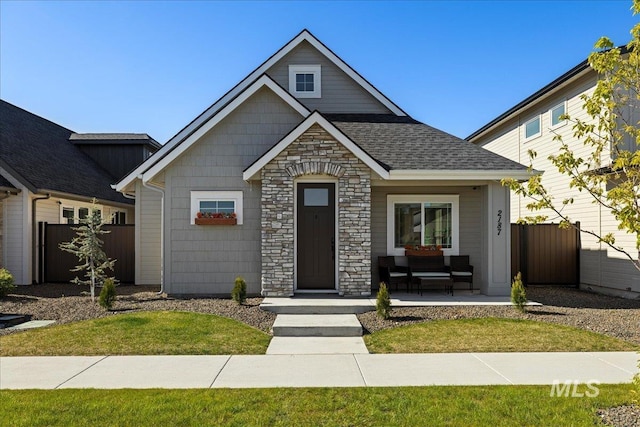 2187 E Hidcote St, Meridian, ID 83642 - view of front of property with stone siding, covered porch, and roof with shingles
