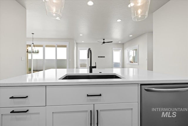 2187 E Hidcote St, Meridian, ID 83642 - kitchen featuring dishwasher, a sink, light countertops, healthy amount of natural light, and recessed lighting
