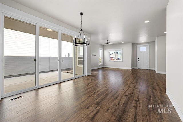 2187 E Hidcote St, Meridian, ID 83642 - unfurnished dining area with a chandelier, baseboards, dark wood-type flooring, recessed lighting, and a ceiling fan