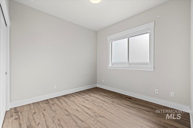 2187 E Hidcote St, Meridian, ID 83642 - unfurnished room featuring wood finished floors and baseboards