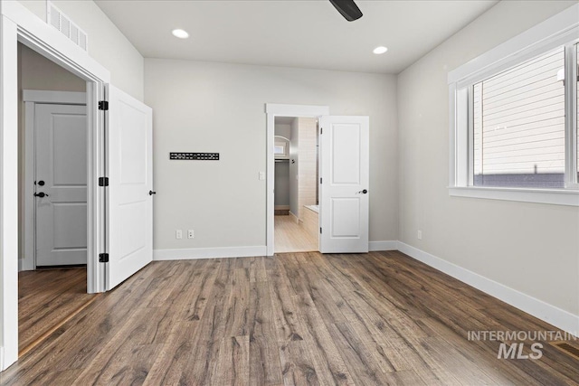 2187 E Hidcote St, Meridian, ID 83642 - unfurnished bedroom with baseboards, wood finished floors, a spacious closet, and recessed lighting