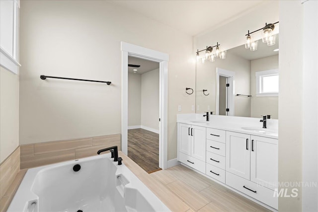 2187 E Hidcote St, Meridian, ID 83642 - full bath with double vanity, a garden tub, and wood finished floors