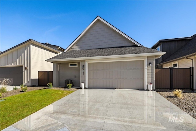 2187 E Hidcote St, Meridian, ID 83642 - view of front facade with concrete driveway, a garage, central AC, and roof with shingles
