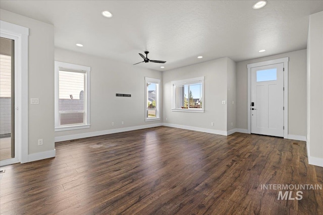 2187 E Hidcote St, Meridian, ID 83642 - unfurnished living room featuring dark wood finished floors, a ceiling fan, baseboards, and recessed lighting