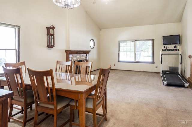 3344 N Tumbleweed, Boise, ID 83713 - dining room featuring light carpet, a chandelier, lofted ceiling, and a fireplace