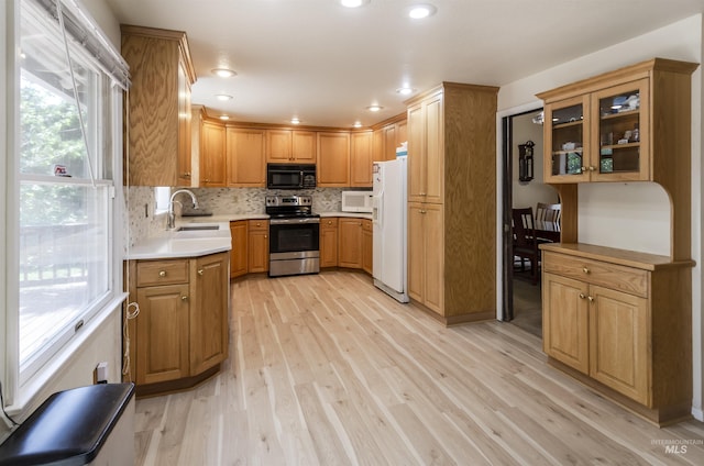 3344 N Tumbleweed, Boise, ID 83713 - kitchen featuring white appliances, a sink, light wood finished floors, decorative backsplash, and light countertops
