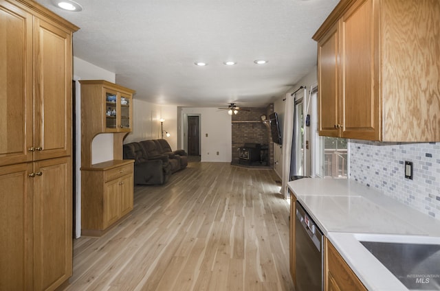 3344 N Tumbleweed, Boise, ID 83713 - kitchen featuring stainless steel dishwasher, open floor plan, light wood-type flooring, brown cabinetry, and decorative backsplash