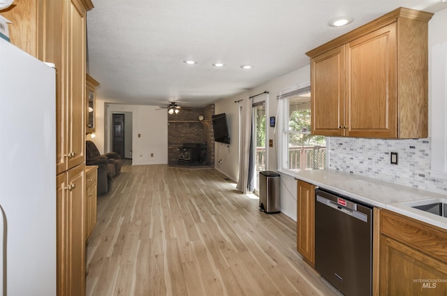 3344 N Tumbleweed, Boise, ID 83713 - kitchen featuring stainless steel dishwasher, freestanding refrigerator, open floor plan, light wood-type flooring, and light countertops