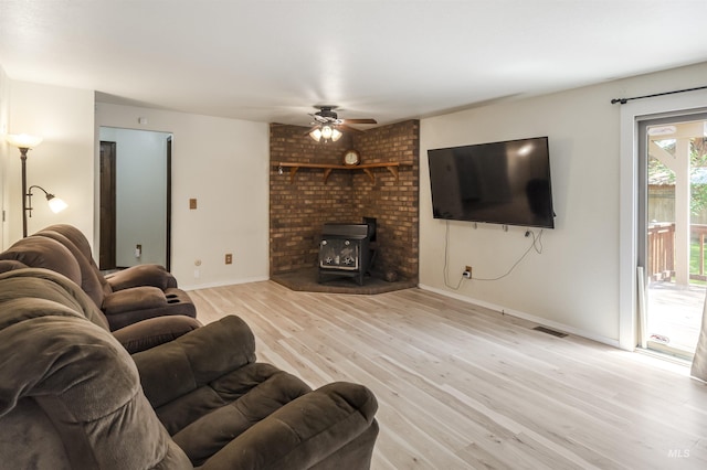 3344 N Tumbleweed, Boise, ID 83713 - living room featuring a wood stove, a ceiling fan, wood finished floors, and baseboards