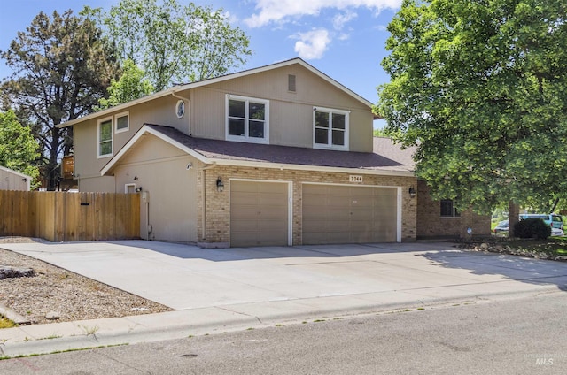 3344 N Tumbleweed, Boise, ID 83713 - view of front of property with a garage, driveway, brick siding, and stucco siding