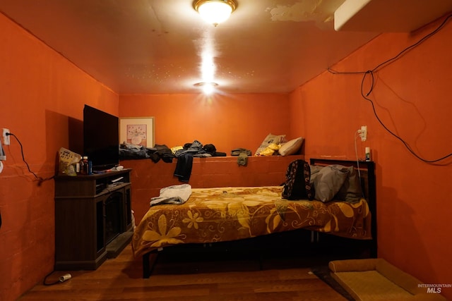 bedroom featuring wood finished floors