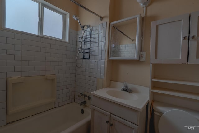 bathroom with toilet, vanity, and bathtub / shower combination