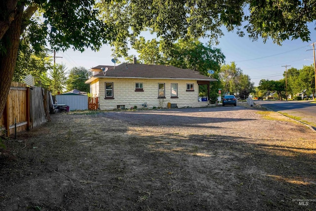 back of house with fence