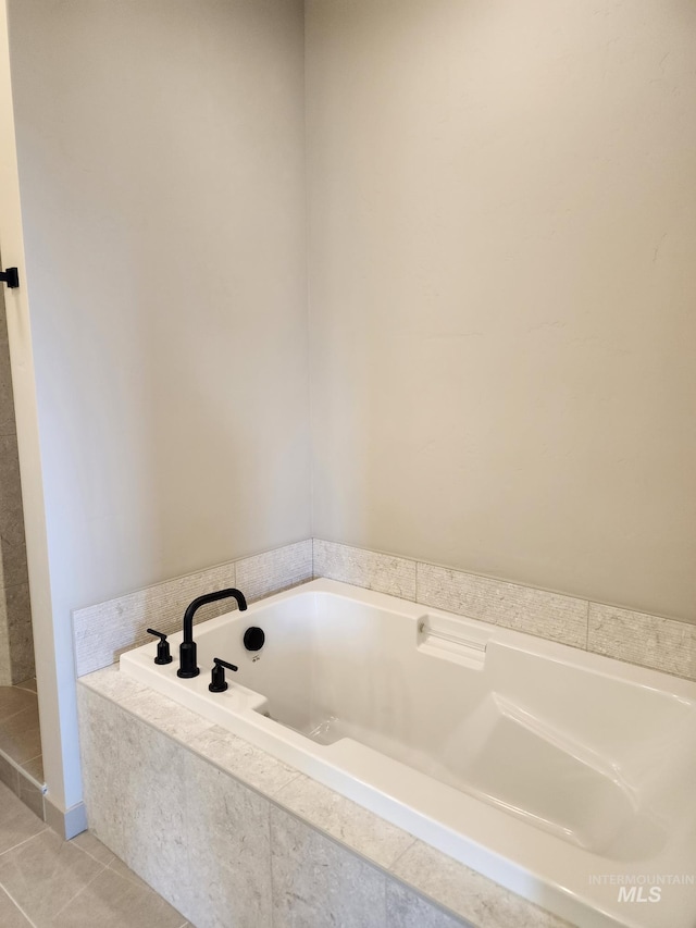 full bath featuring a garden tub and tile patterned flooring