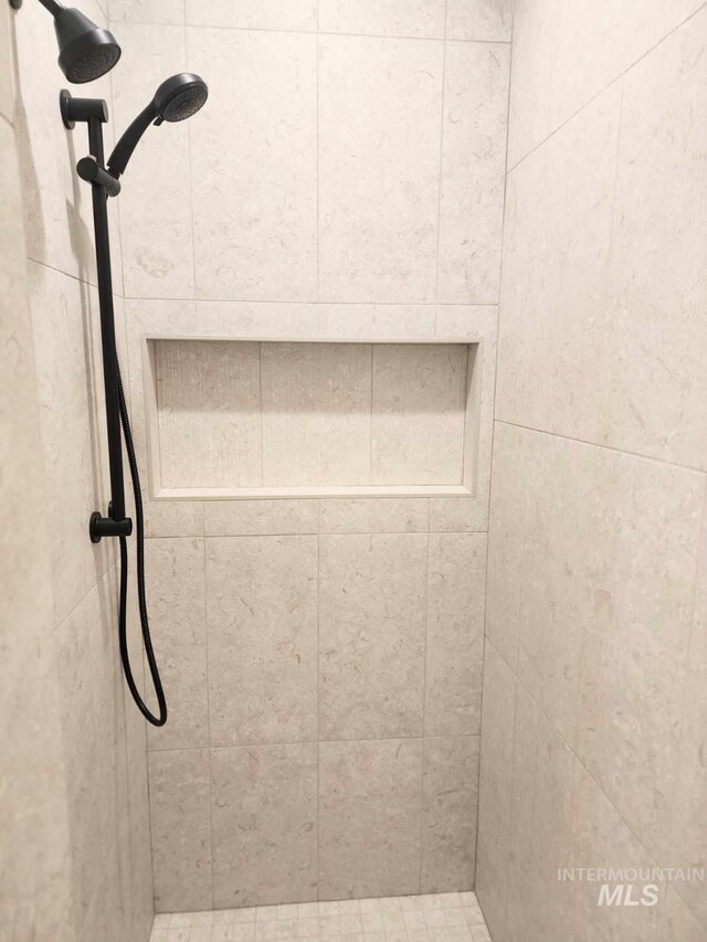 bathroom with a tile shower