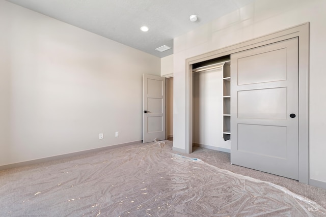 unfurnished bedroom featuring baseboards, recessed lighting, and a closet