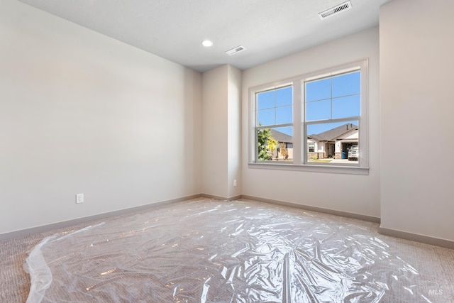 unfurnished room with recessed lighting, visible vents, and baseboards