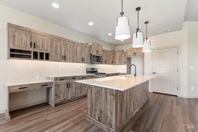 kitchen featuring a sink, wood finished floors, stainless steel appliances, and tasteful backsplash