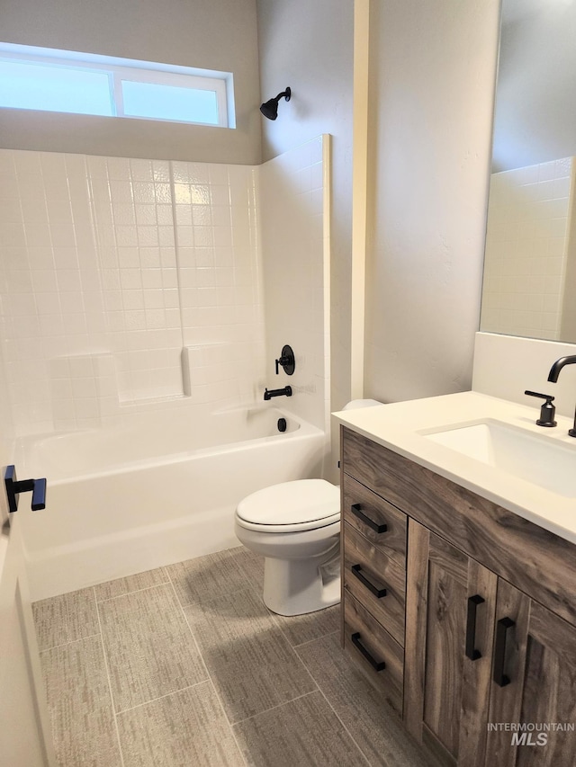 bathroom with shower / bathing tub combination, toilet, and vanity