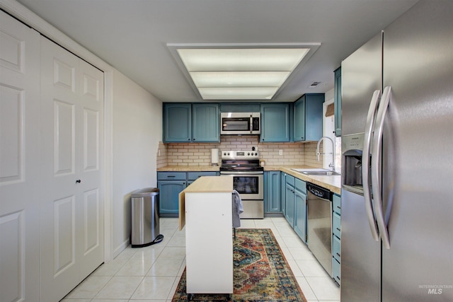1214 E Pennsylvania Pl, Nampa, ID 83686 - kitchen with appliances with stainless steel finishes, blue cabinetry, a sink, and light countertops
