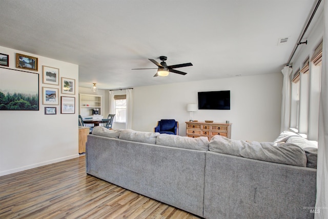1214 E Pennsylvania Pl, Nampa, ID 83686 - living area with wood finished floors, a ceiling fan, and baseboards