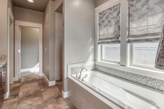 full bath with a bath and vanity