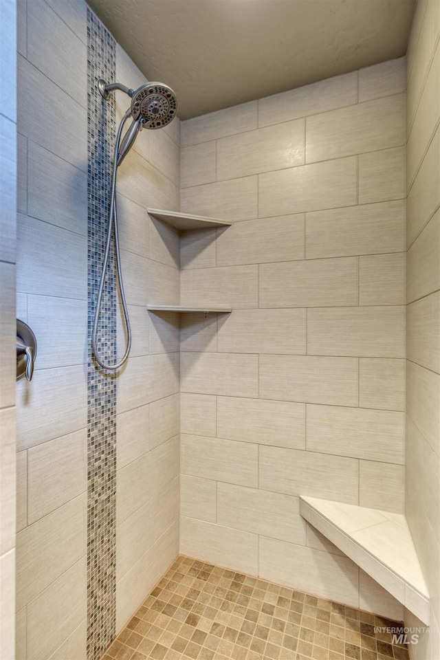full bathroom with tiled shower