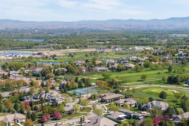 birds eye view of property featuring a water and mountain view, golf course view, and a residential view