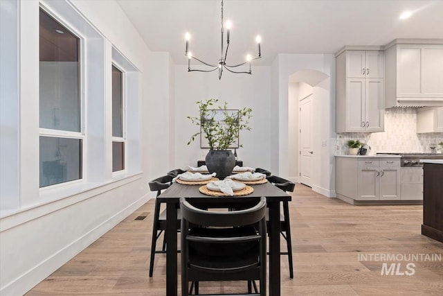 dining room featuring an inviting chandelier and light hardwood / wood-style floors