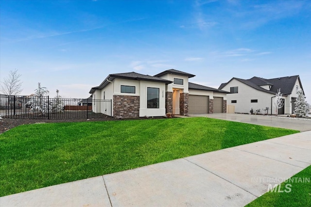 view of front of home with a front yard and a garage