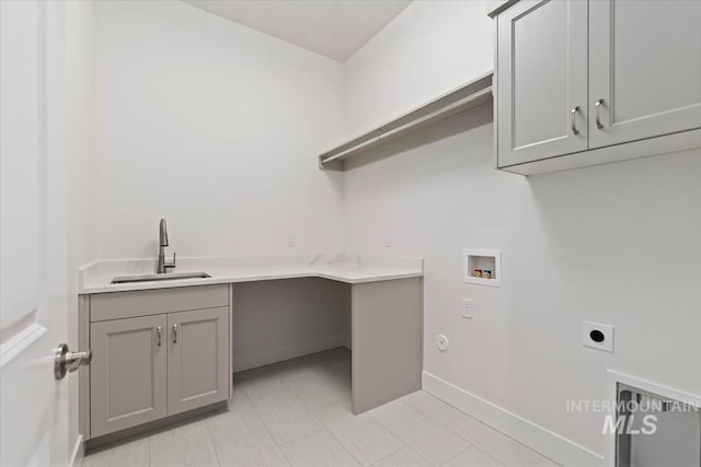 washroom with hookup for a washing machine, sink, cabinets, and electric dryer hookup