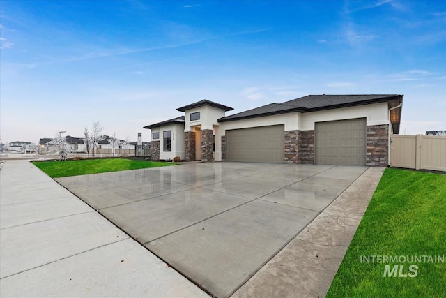 prairie-style house featuring a front yard and a garage