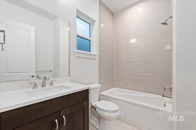full bathroom featuring tiled shower / bath combo, toilet, and vanity