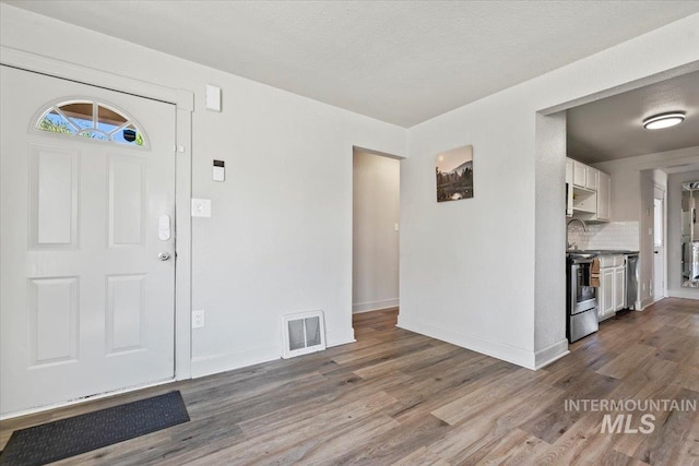 2706 W Ponderosa Rd, Boise, ID 83705 - foyer with baseboards, visible vents, and dark wood-style floors