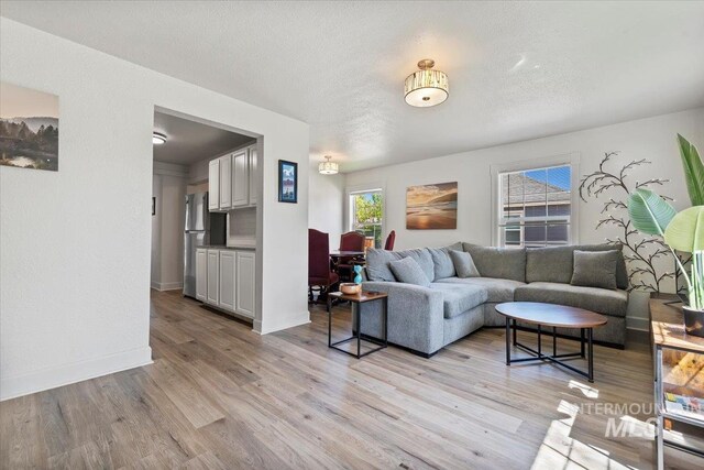 2706 W Ponderosa Rd, Boise, ID 83705 - living area featuring baseboards and light wood finished floors