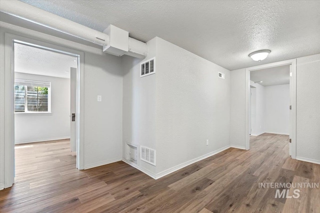 2706 W Ponderosa Rd, Boise, ID 83705 - empty room with visible vents, a textured ceiling, and wood finished floors