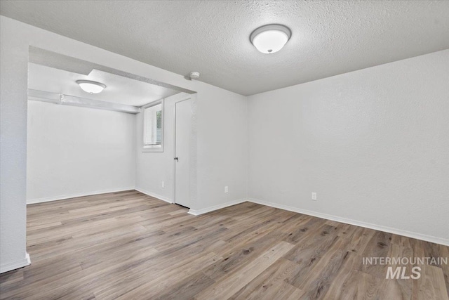 2706 W Ponderosa Rd, Boise, ID 83705 - basement featuring baseboards, a textured ceiling, and wood finished floors