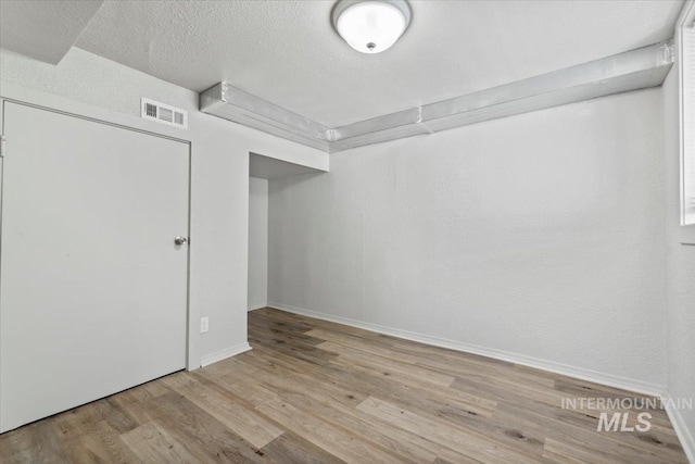 2706 W Ponderosa Rd, Boise, ID 83705 - unfurnished bedroom with visible vents, a textured ceiling, baseboards, and wood finished floors