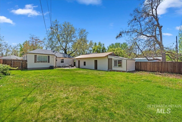 2706 W Ponderosa Rd, Boise, ID 83705 - rear view of property with a fenced backyard, an outbuilding, and a yard