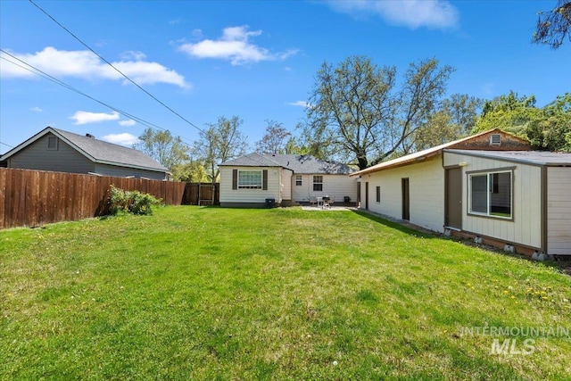 2706 W Ponderosa Rd, Boise, ID 83705 - rear view of house featuring a lawn, a patio, and fence