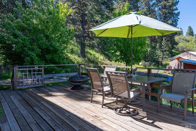 39055 Hilltop Ln, Lewiston, ID 83501 - wooden deck with outdoor dining space and view of scattered trees