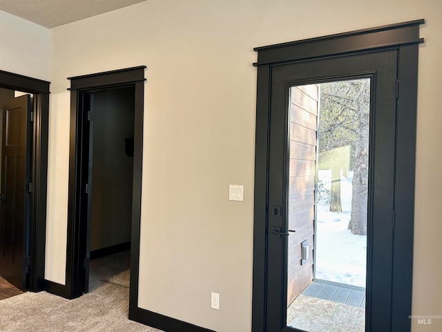 foyer with carpet flooring