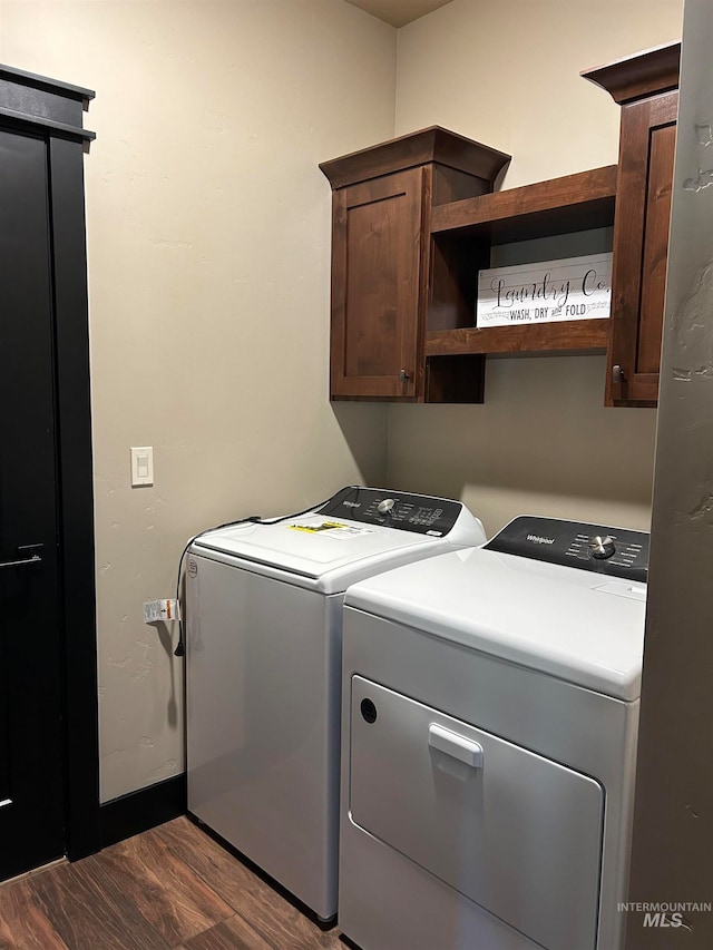 clothes washing area with hardwood / wood-style floors, cabinets, and washer and clothes dryer