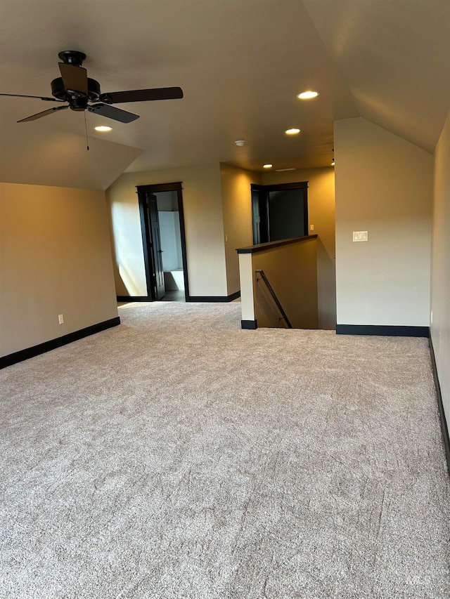 interior space featuring vaulted ceiling, ceiling fan, and carpet flooring