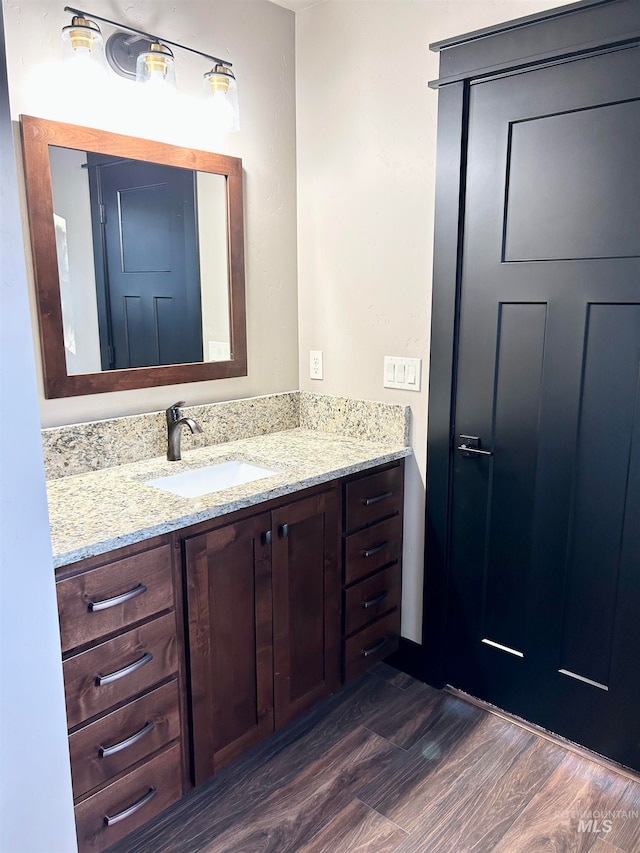 bathroom featuring vanity and hardwood / wood-style flooring